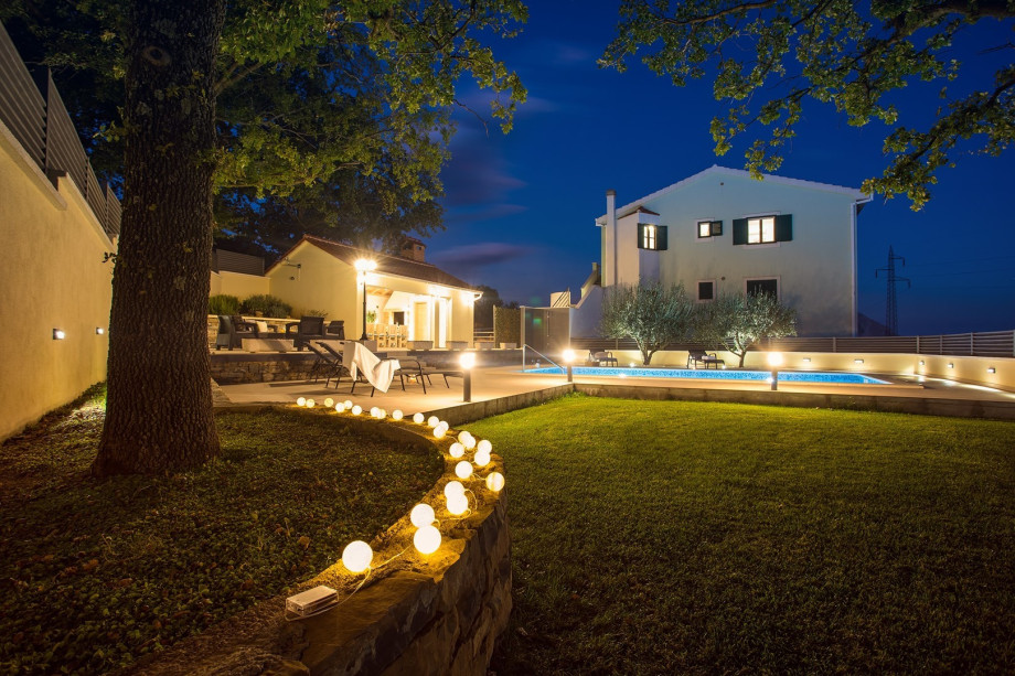 Spacious complete fenced outdoor area by night with great lights