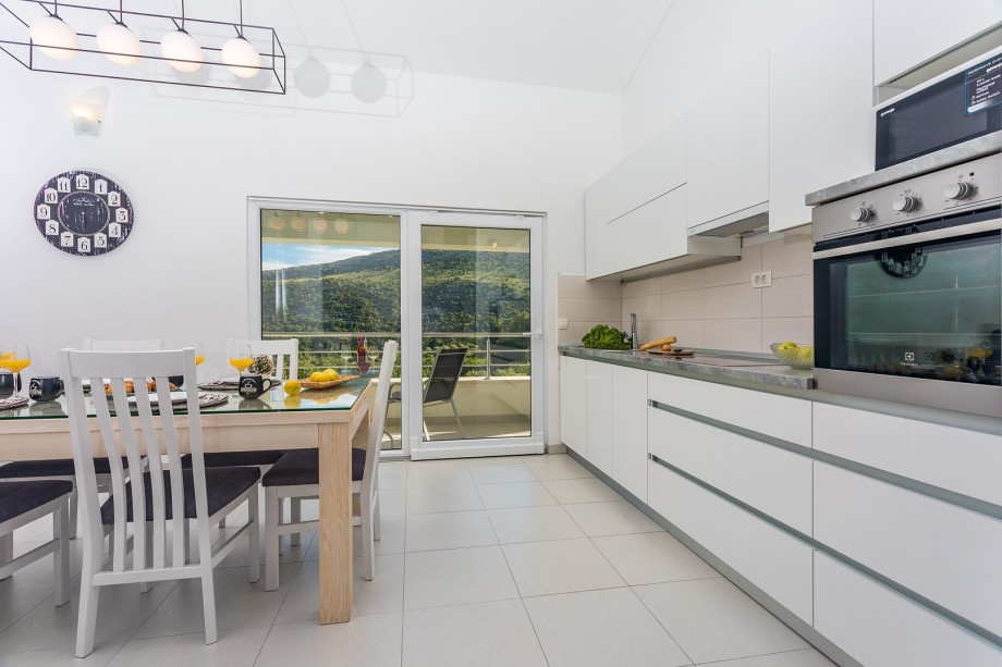 Fully equipped kitchen with dining & living area and exit to the terrace