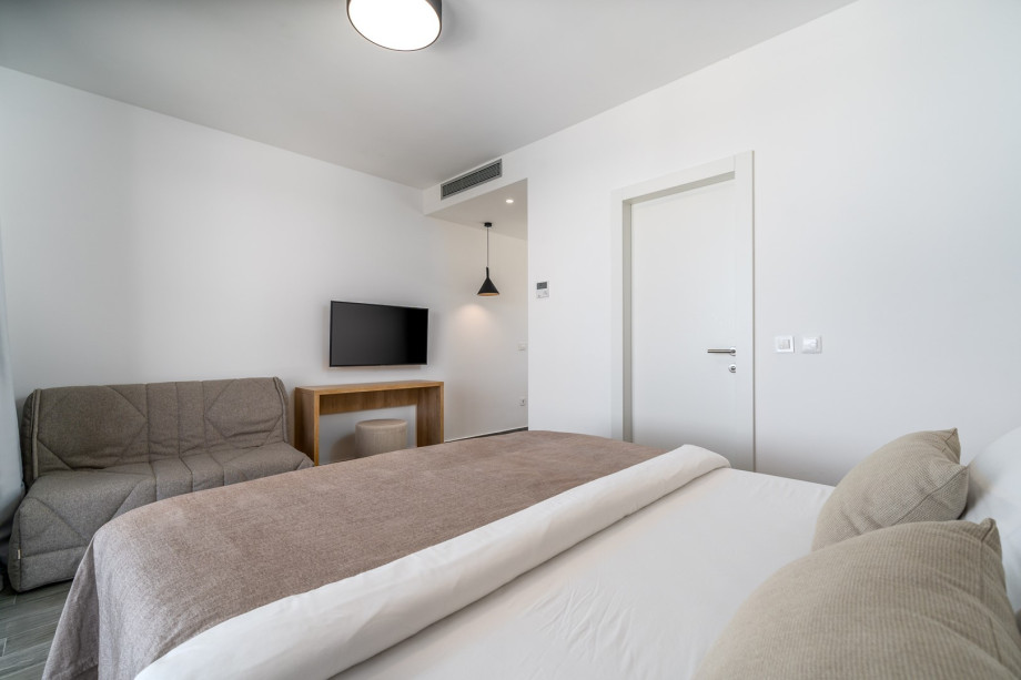 A king size bed 180cm x 210cm, a sofa bed and TV