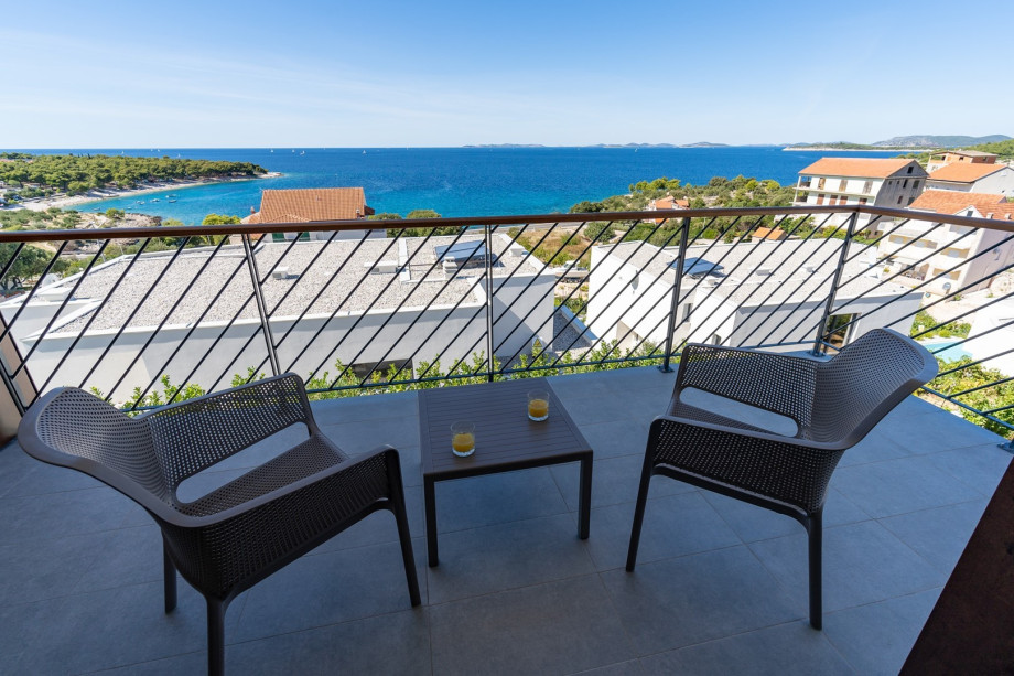 A balcony with outdoor furniture.