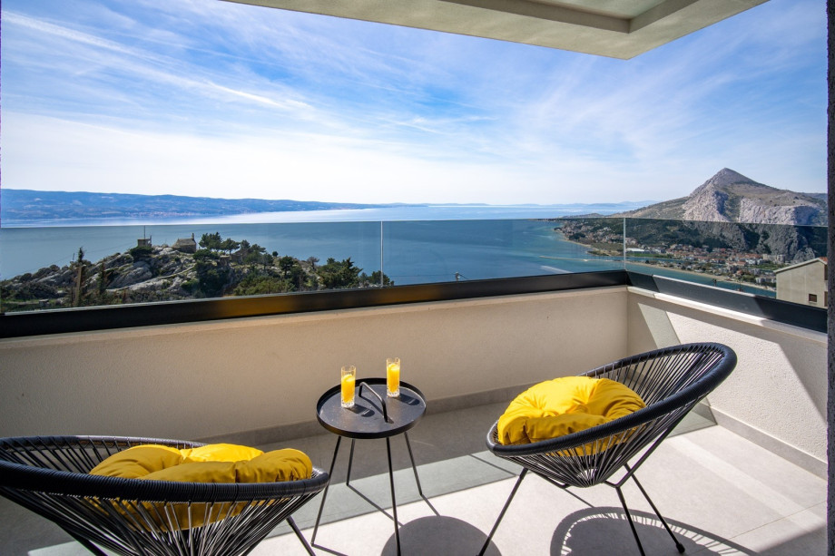 A huge open terrace with comfortable outdoor furniture, overlooking the stunning Adriatic sea and islands