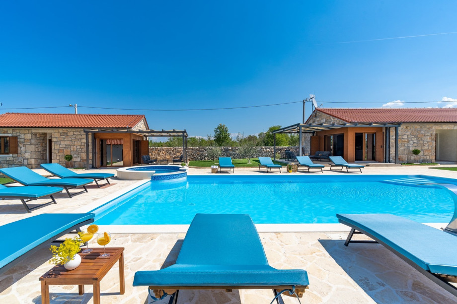 An outdoor shower, spacious sun deck area with 10 deck chairs