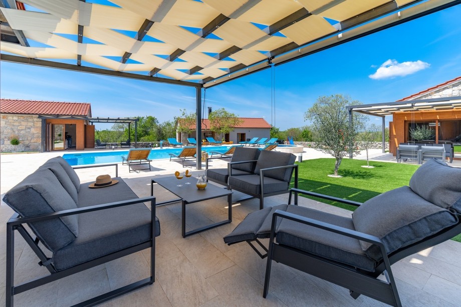 Exit toward pool area with covered lounge corner just in front of the living room