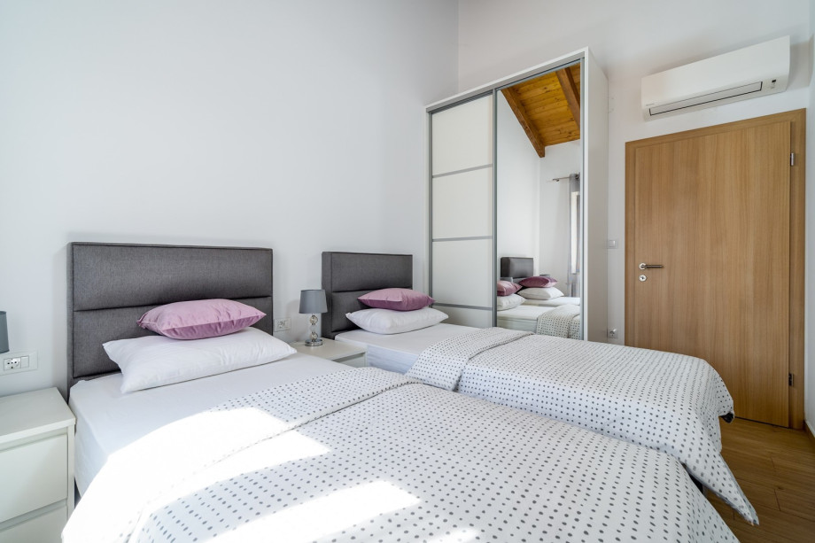 A laundry with washing machine and ironing facilities.