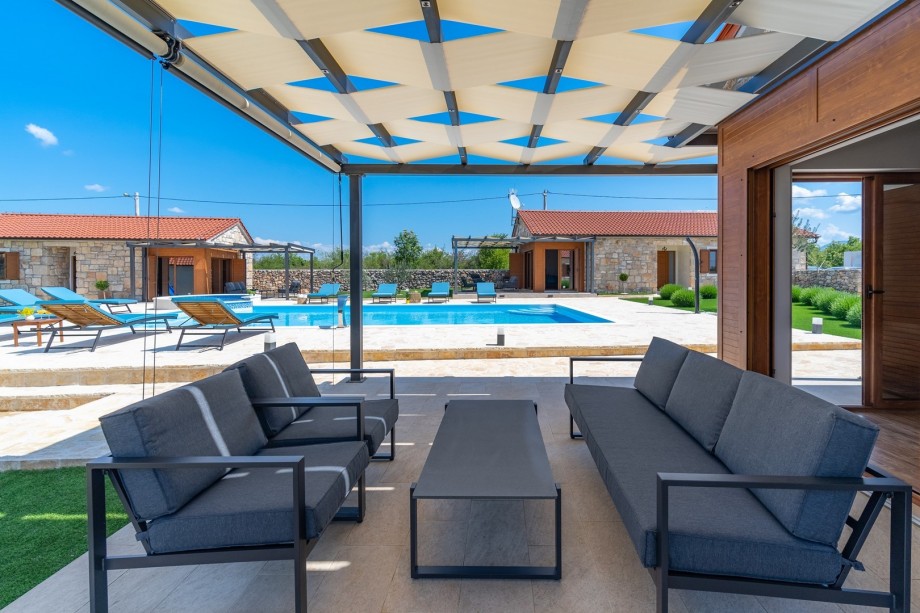 Exit towards the pool area with covered lounge corner just in front of the living room.