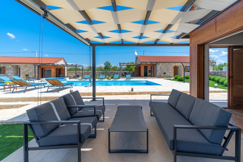 Exit towards the pool area with covered lounge corner just in front of the living room.