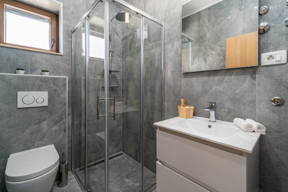 Family bathroom with a shower and a toilet.