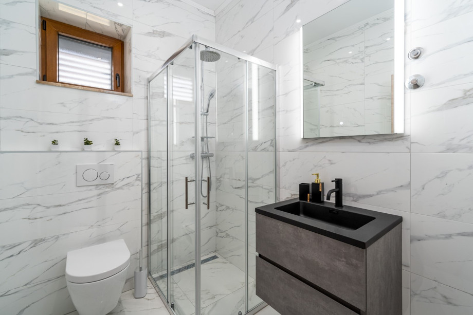 Family bathroom with a shower and a toilet.