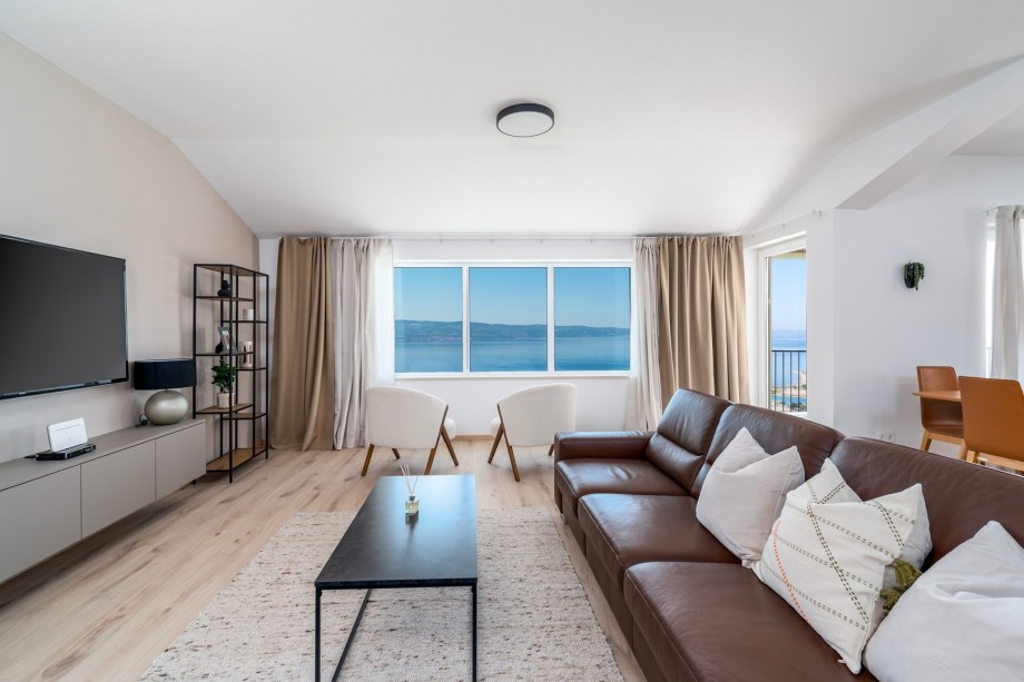 The 2nd floor ( with separate entrance) offers a spacious living area (40sqm) with comfortable sofa, TV, A/C, a panoramic window, a fully equipped kitchen, dining area with exit to a terrace