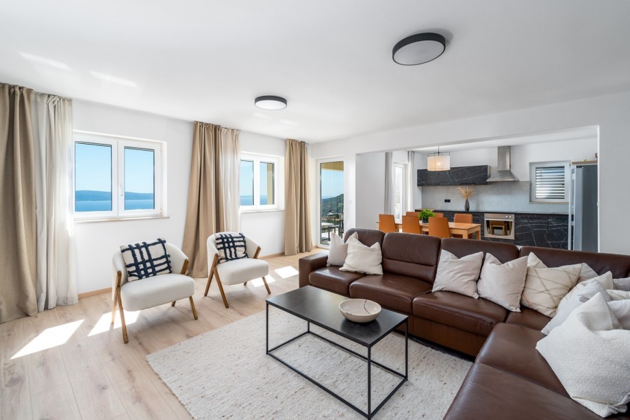 Dining area with exit to the lounge corner and a dining terrace with grill, Family bathroom with a shower, toilet and a bidet, and another smaller family bathroom with a shower and a toilet