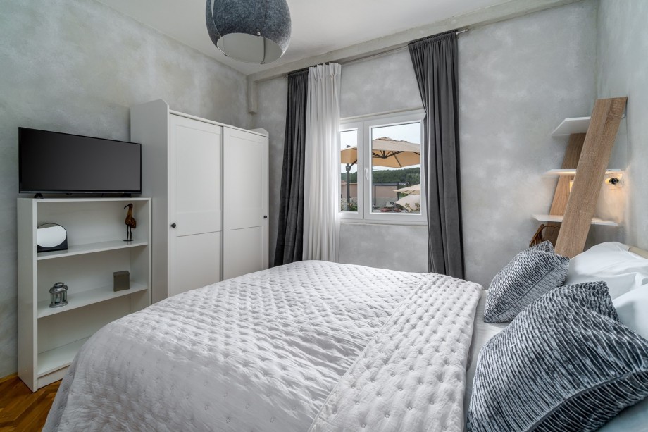 Bedroom NO1 (14sqm) with a queen-size bed 160cm x 200cm, a TV, and pool views