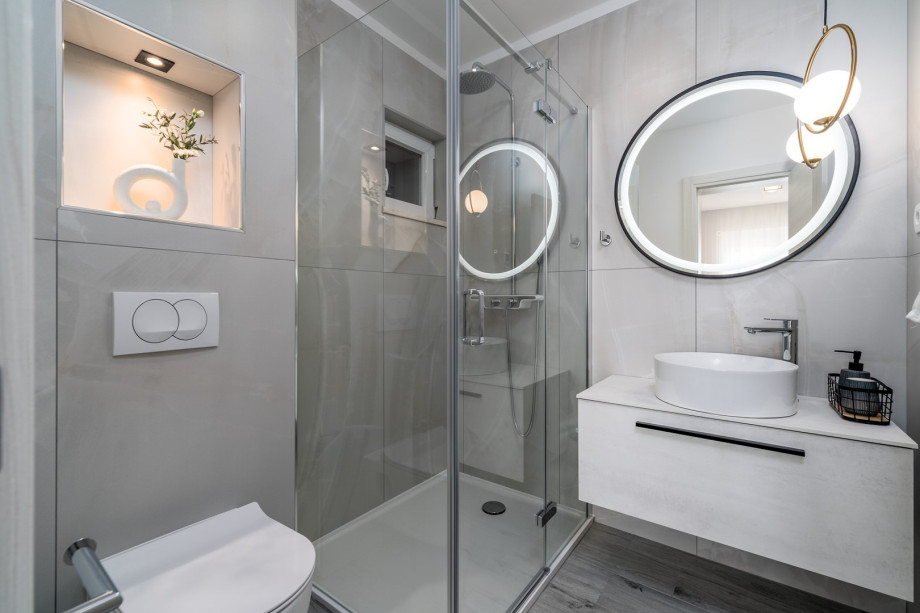 An en-suite bathroom with a shower, a sink, and a toilet