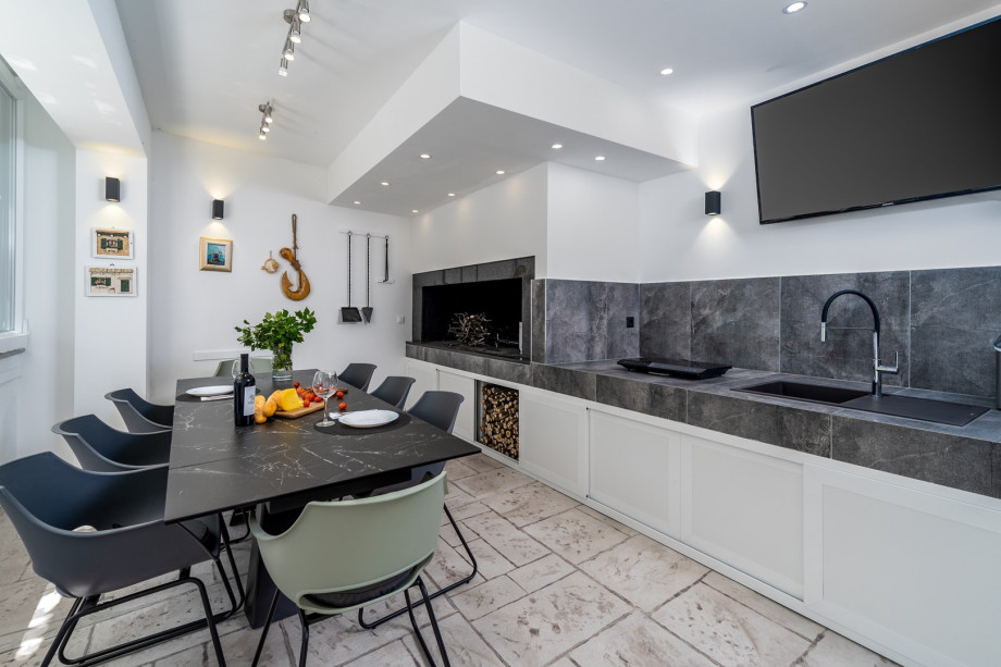 At the pool level (ground floor level) is a summer kitchen