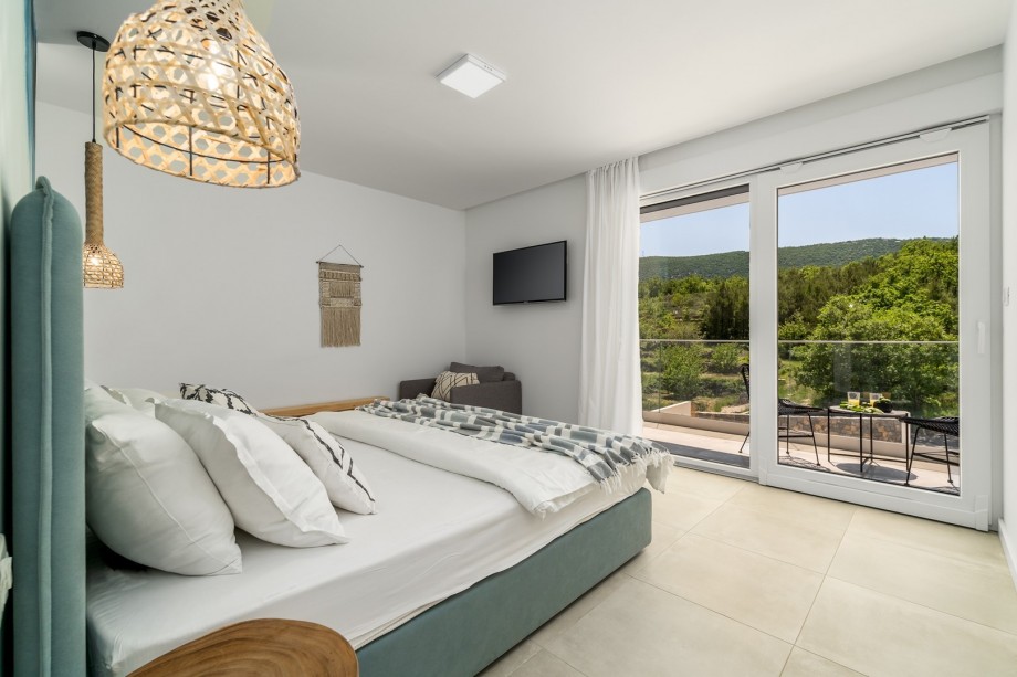 A Master Bedroom No 4 with king-size bed 180cm x 200cm, TV, A/C, ensuite bathroom with shower, a balcony with pool views.