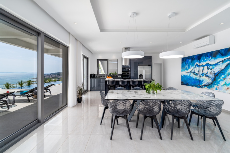Contemporary open concept kitchen and dining room with sea views