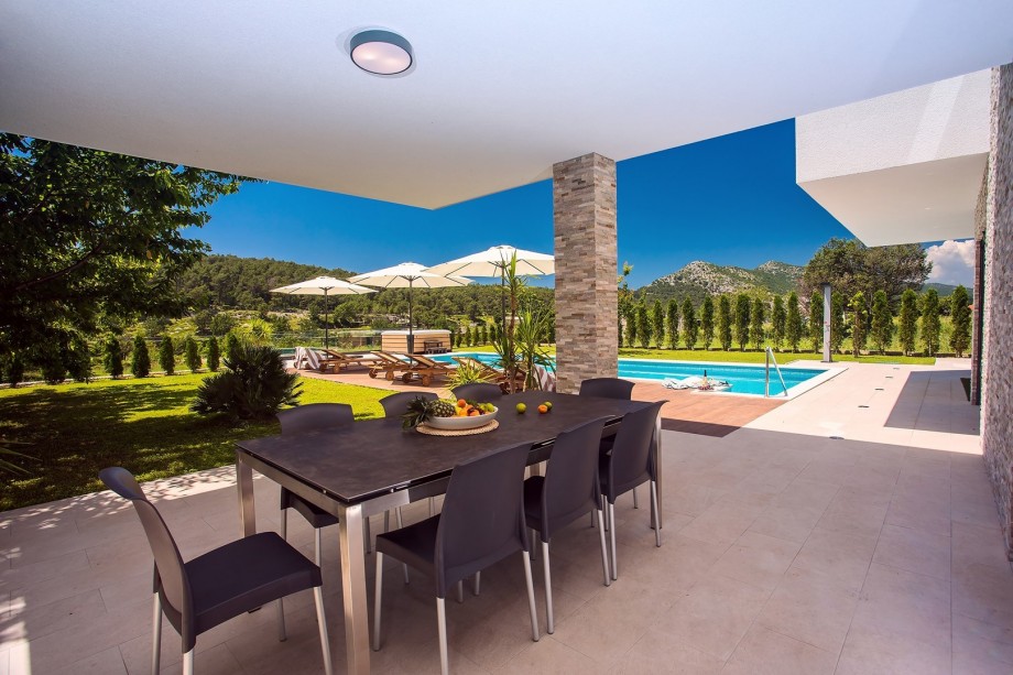 The outdoor area offers covered outdoor dining area with a barbecue