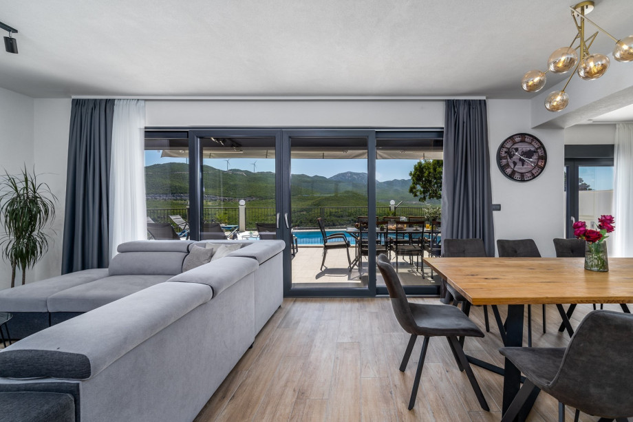 The Ground floor (50sqm) offers a fully air-conditioned and equipped kitchen, a dining area, and a living area