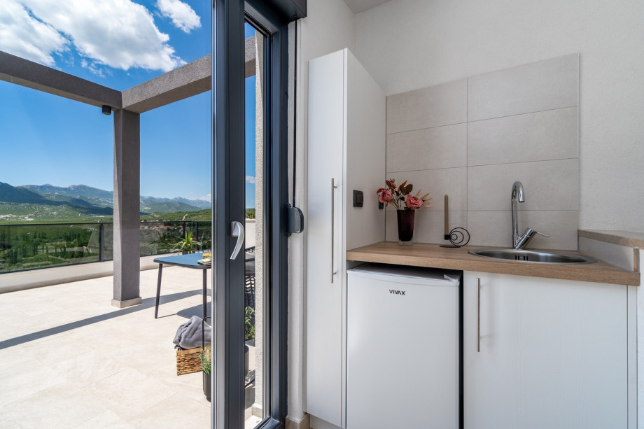 Next to it there is a Kitchenette with a fridge, and a terrace (50sqm)
