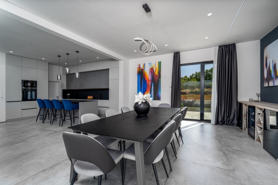 There is a direct approach to the outdoor dining area and pool area from the indoors.