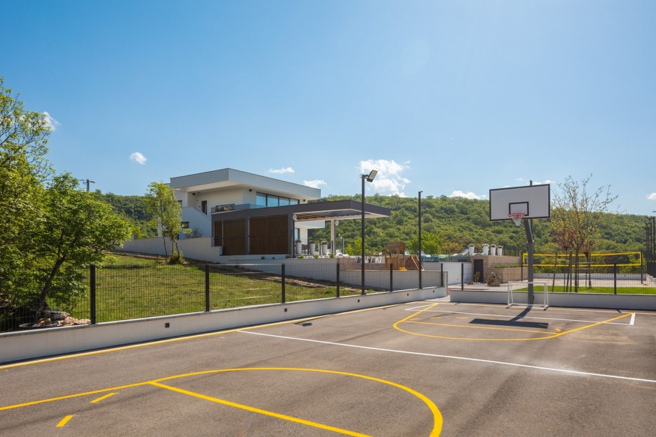A basketball court and a volleyball sand court for showing your sports skills