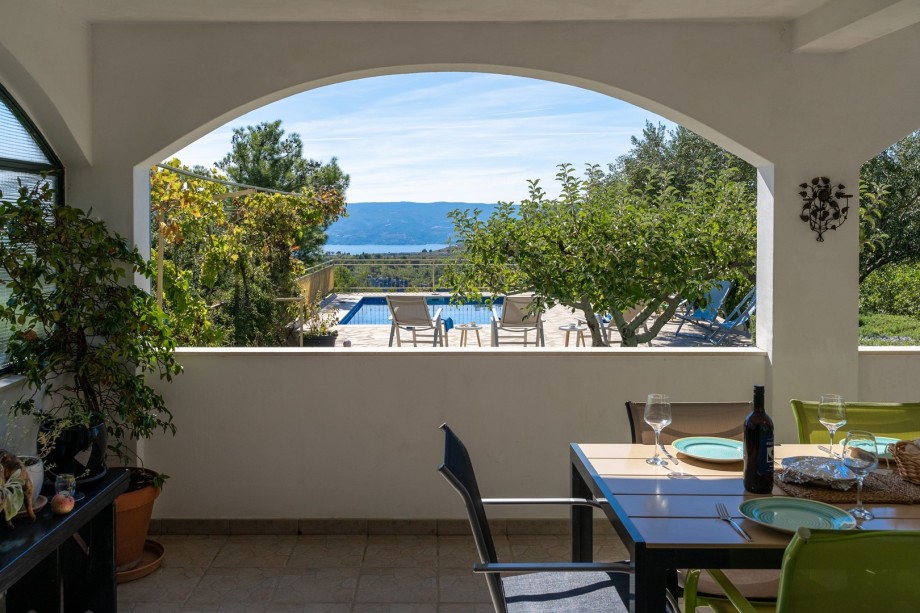 There is an outdoor covered dining area for 8 people with an amazing panorama