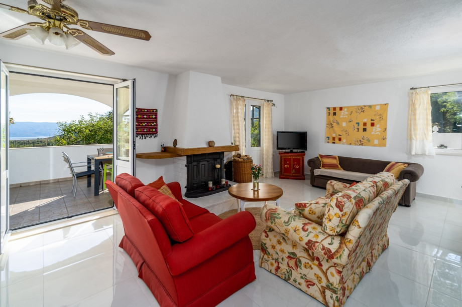 A cozy living room with a TV, fireplace, and TV
