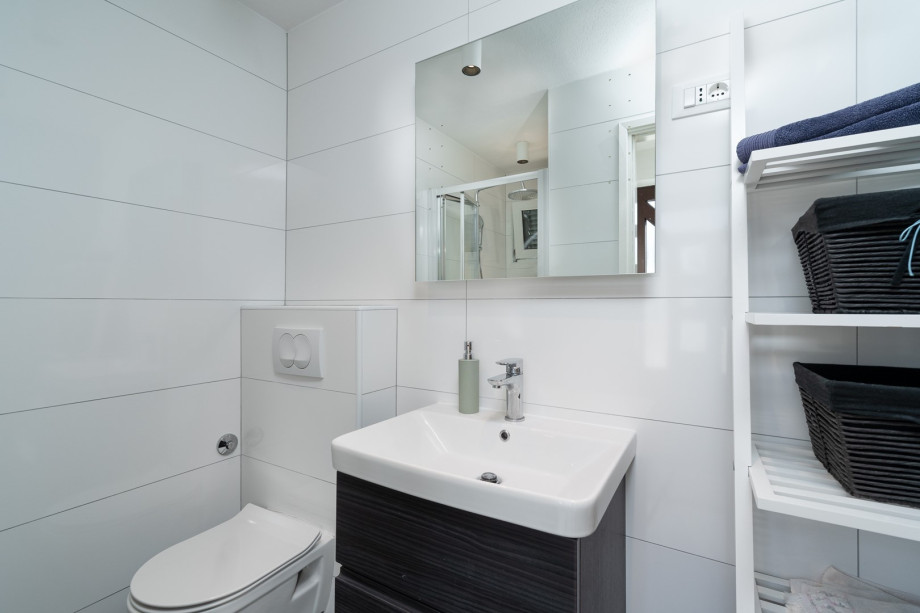 A family bathroom located on the first floor with a shower, a sink, and a toilet