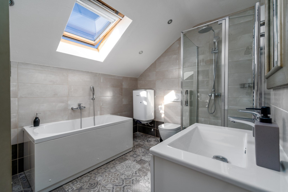 A family bathroom with a bathtub, a shower, a sink, and a toilet