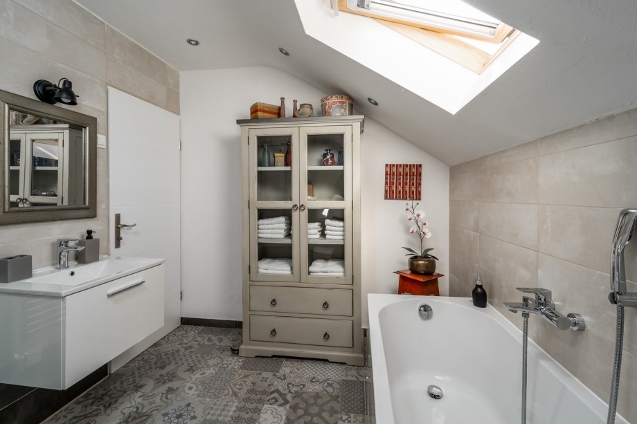 A family bathroom with a bathtub, a shower, a sink, and a toilet