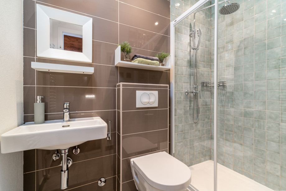 An en-suite bathroom with a shower, a sink, and a toilet