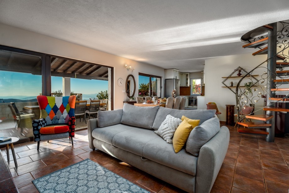 Dining and living room, fully equipped kitchen, TV, fire place and exit to terrace