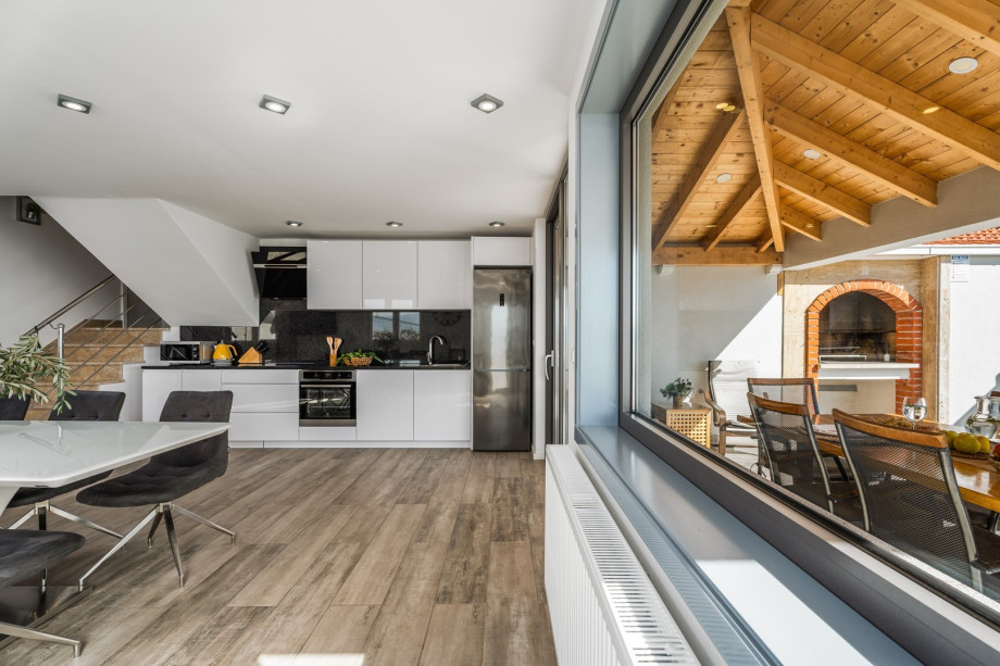 Direct exit from the kitchen to the outdoor dining area and grill