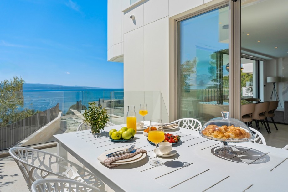An outdoor dining area with a barbecue (gas). which you can approach directly from the kitchen