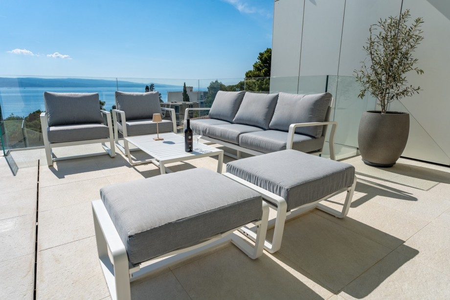 At the pool level is a covered deck area with a lounge corner