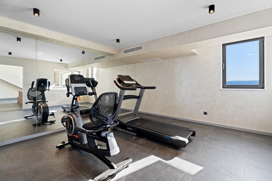 A Gym area offers an Exercise bike and a Treadmill, a TV and air-conditioning
