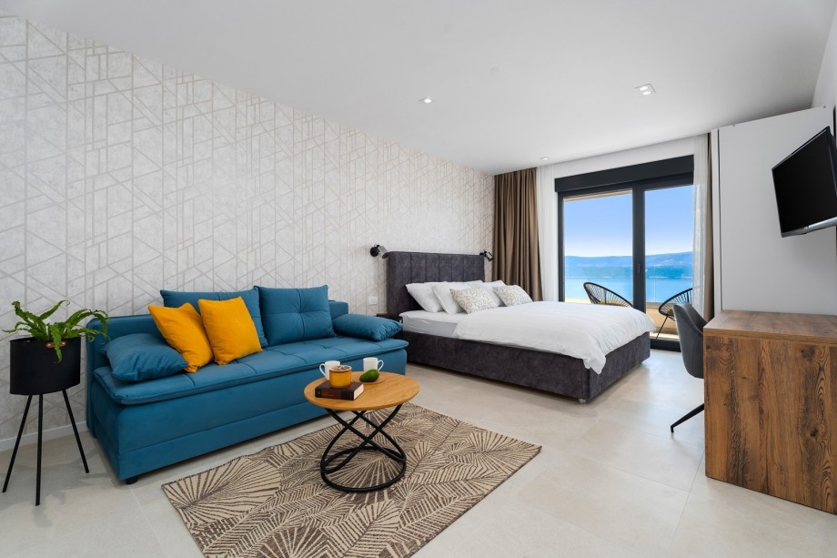 Bedroom NO1 with a king-size bed , A/C, a TV, and a sofa that can convert into a sleeping place for +2