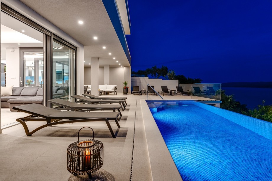 Seating deck areas near the outstanding pool, with sea views.