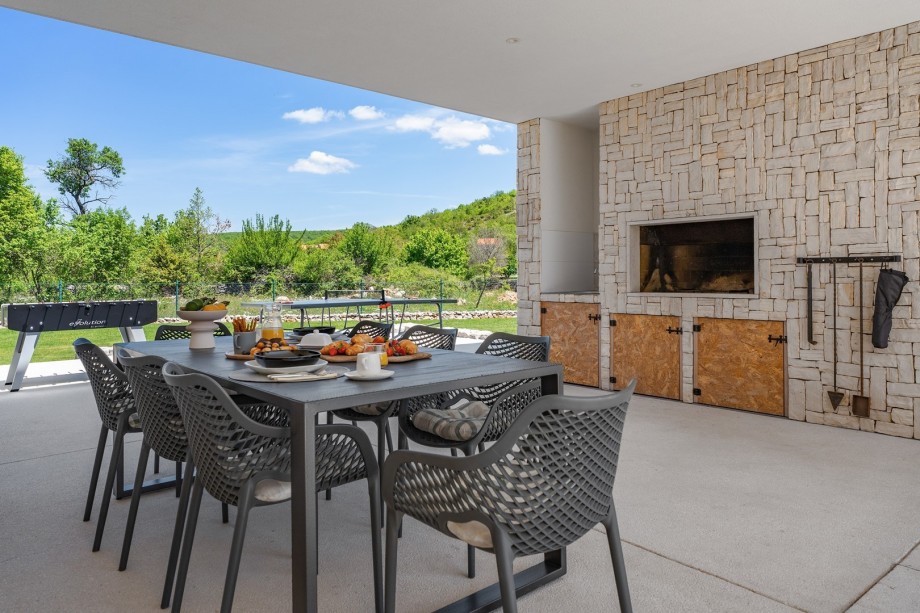 outdoor dinning area with BBQ and TV, very spacious
