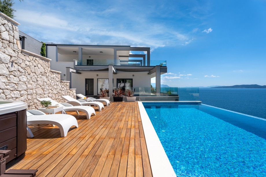 Pool level, middle-level offers heated, infinity 4m x 8m swimming pool with hydro massage, a Whirlpool next to the pool, 8 sundeck chairs, 2 parasols