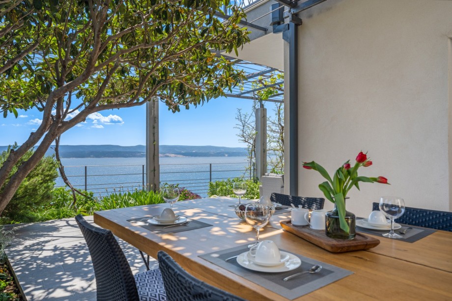 Outdoor dining area with BBQ on the east side of the villa (lowest level)
