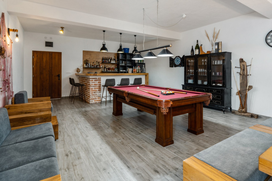 The Fun zone offers summer kitchen, dining table, sofa, billiard and A/C