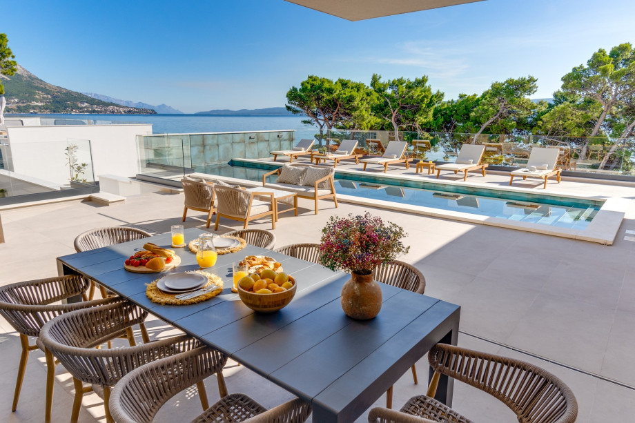 The outdoor offers a covered dining area with a barbecue and direct entrance to the living area