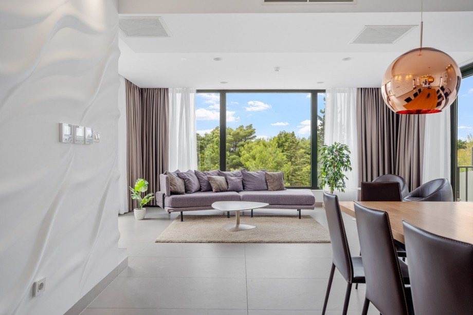 Living and dining area with  sea views, fire place, TV, exit to outdoor dining