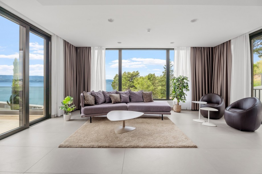 Glass wall in living room gives you opportunity to enjoy sea views