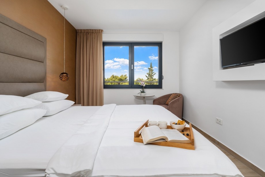 One of 4 bedrooms with double bed 180x210cm, en-suite bathroom, TV and sofa bed