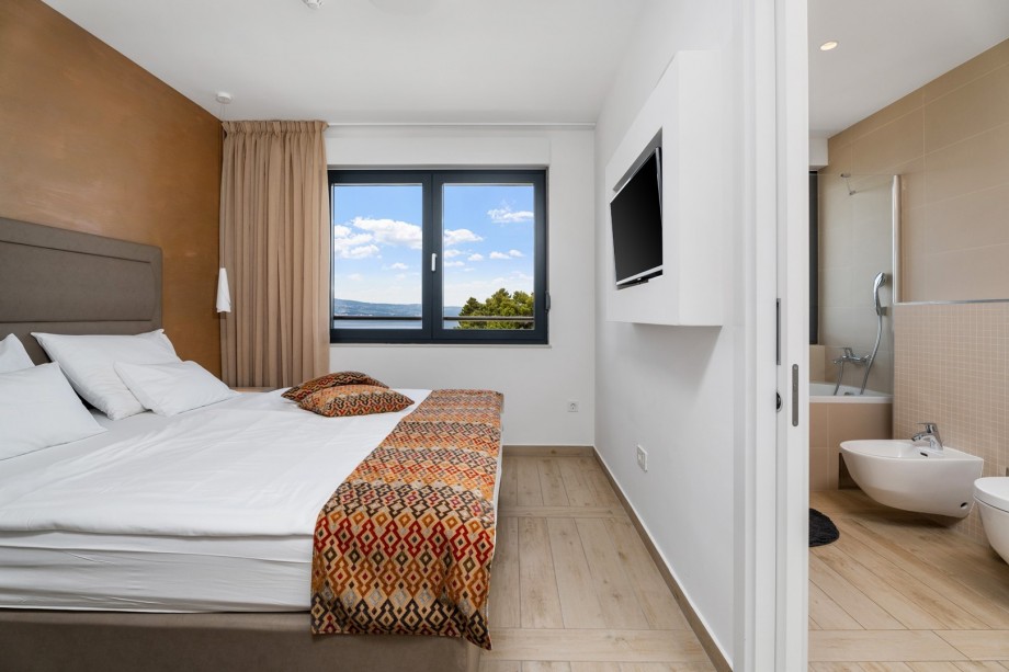 One of 2 bedrooms with king size bed 180x210cm, en-suite bathroom, TV