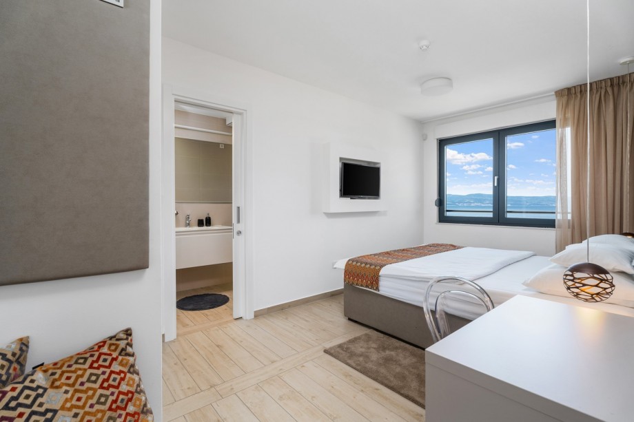 One of 4 bedrooms with double bed 180x210cm, en-suite bathroom, TV and sofa bed