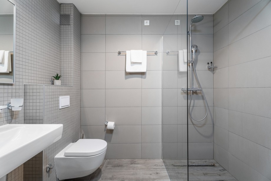 Bathroom with shower at gym and sauna level