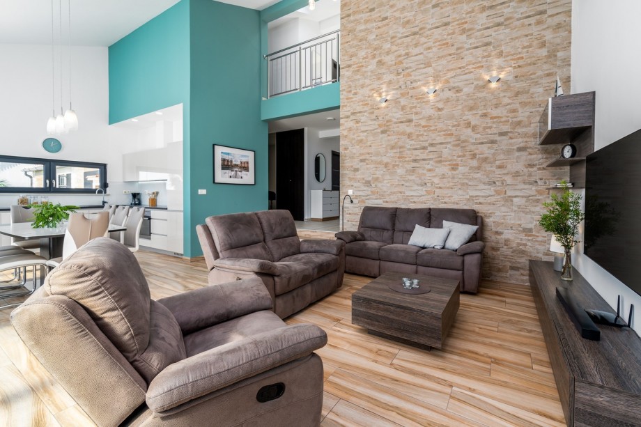 Tastefully furnished living area with exit to pool