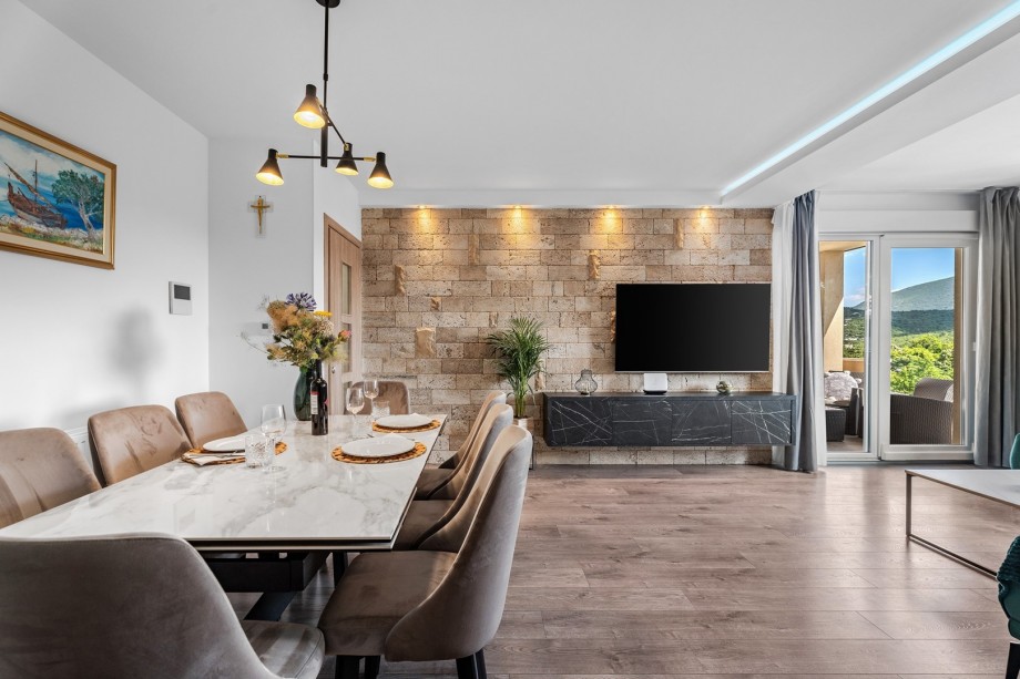 Spacius dinig and living area with a pool view.